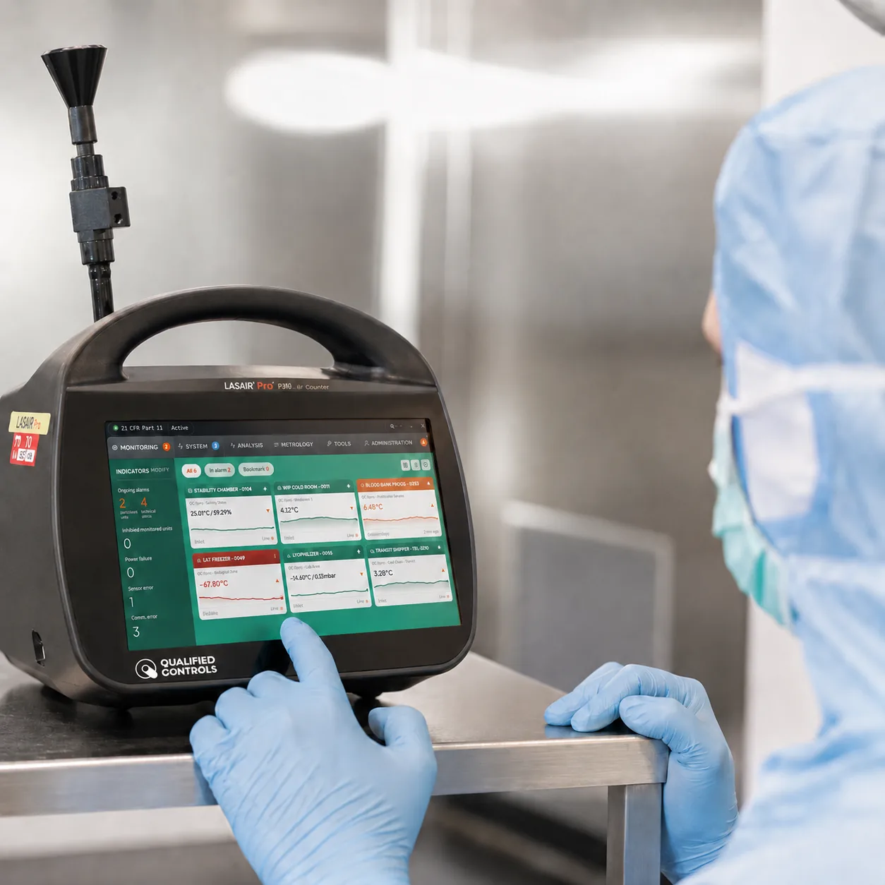 Gowned operator using a portable airborne particle counter running the MySirius Clean Room monitoring dashboard inside a classified cleanroom